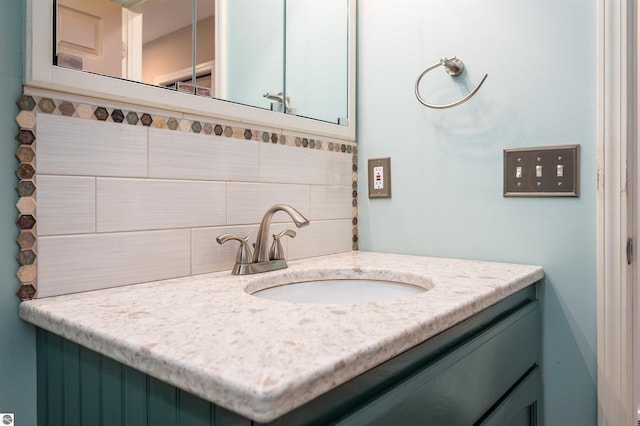 bathroom with vanity and tasteful backsplash