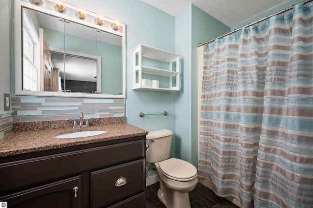 bathroom featuring a shower with curtain, backsplash, toilet, a textured ceiling, and vanity