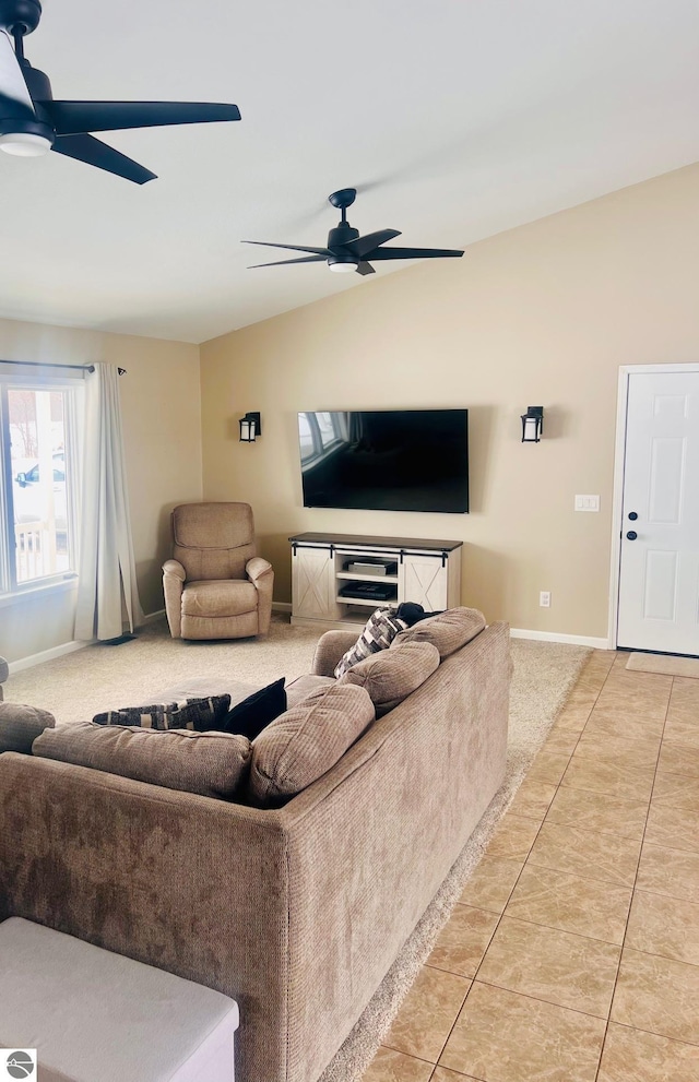 living room with lofted ceiling, light tile patterned flooring, and ceiling fan