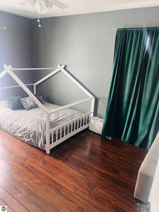 bedroom featuring ceiling fan and dark hardwood / wood-style flooring