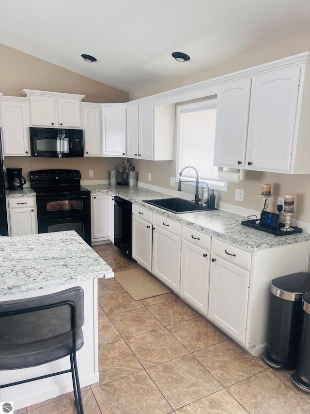 kitchen featuring white cabinetry, sink, black appliances, and lofted ceiling