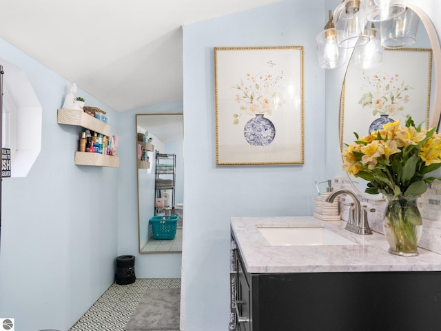 bathroom with vanity and vaulted ceiling