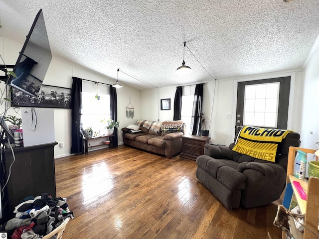 living room featuring wood-type flooring, a textured ceiling, and lofted ceiling