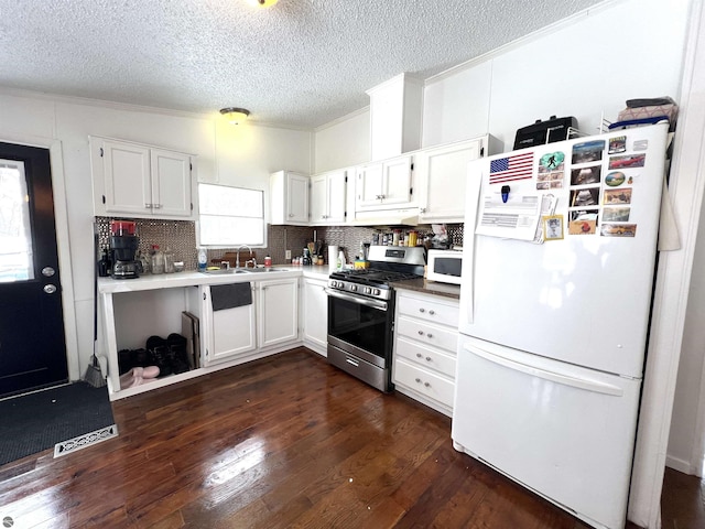 kitchen featuring white appliances, decorative backsplash, sink, white cabinetry, and dark hardwood / wood-style floors