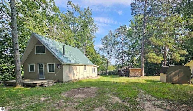 back of property featuring a shed and a yard