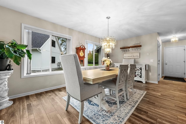 dining area featuring a chandelier and wood-type flooring