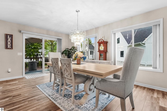 dining room featuring a chandelier and light hardwood / wood-style flooring