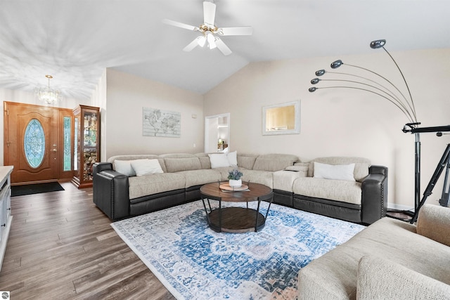 living room with ceiling fan, dark hardwood / wood-style floors, and lofted ceiling