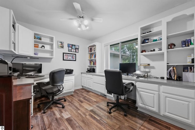 office with ceiling fan, built in desk, and dark hardwood / wood-style floors