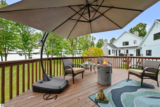 deck with a yard and a fire pit