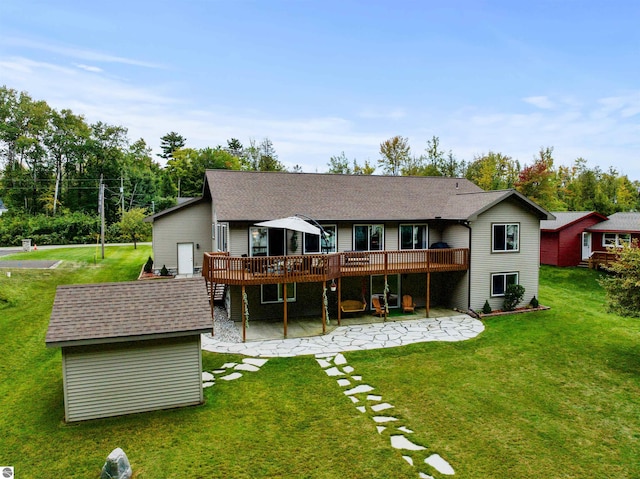 back of property featuring a lawn, a patio, and a wooden deck