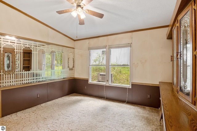 unfurnished room featuring ceiling fan, ornamental molding, carpet floors, and lofted ceiling