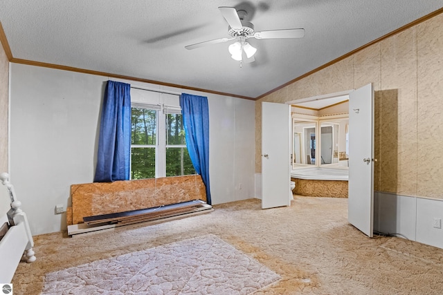 carpeted bedroom with ceiling fan, vaulted ceiling, a textured ceiling, and ornamental molding