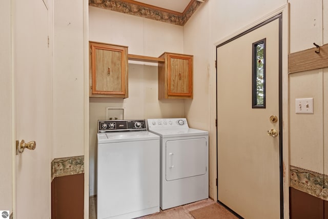 laundry area with separate washer and dryer and cabinets