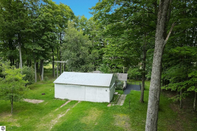 view of outbuilding with a yard