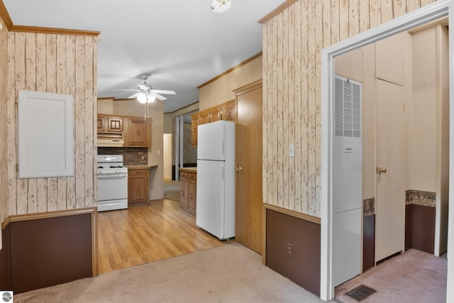 kitchen with light hardwood / wood-style flooring, white appliances, ceiling fan, decorative backsplash, and ornamental molding