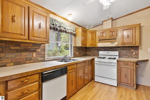 kitchen with white appliances, light hardwood / wood-style floors, lofted ceiling, and sink