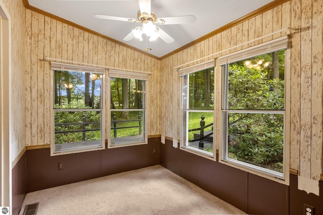 unfurnished sunroom with ceiling fan