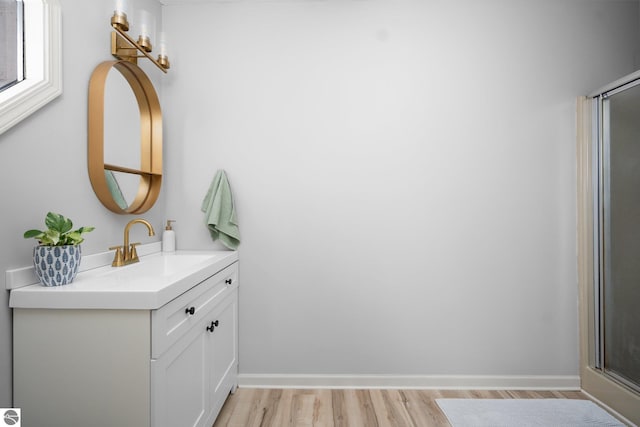 bathroom with hardwood / wood-style floors and vanity