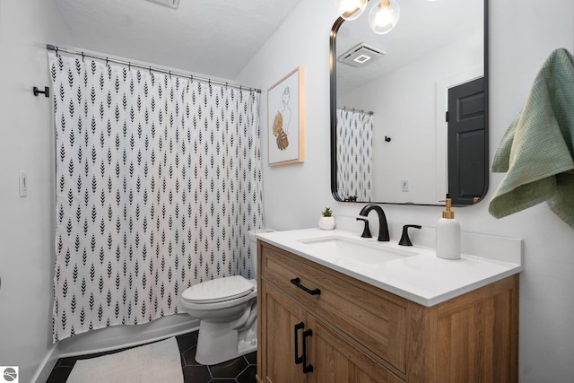 full bathroom with tile patterned flooring, shower / bath combo with shower curtain, vanity, and toilet