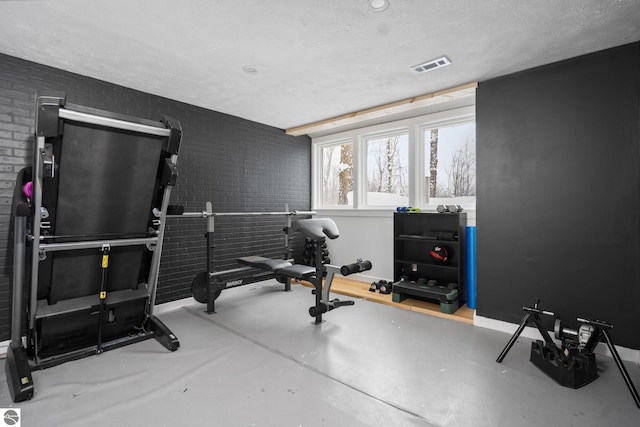 workout area with a textured ceiling