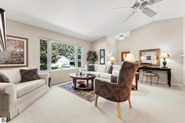 carpeted living area featuring ceiling fan, baseboards, and vaulted ceiling