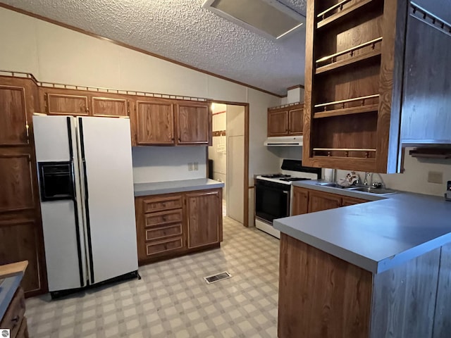 kitchen featuring light floors, white refrigerator with ice dispenser, vaulted ceiling, open shelves, and range with gas cooktop