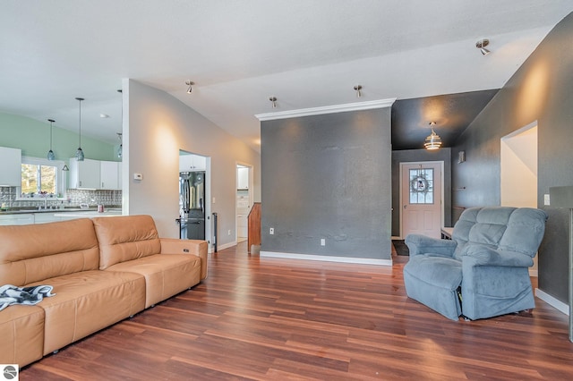 living room with lofted ceiling, dark wood finished floors, and baseboards