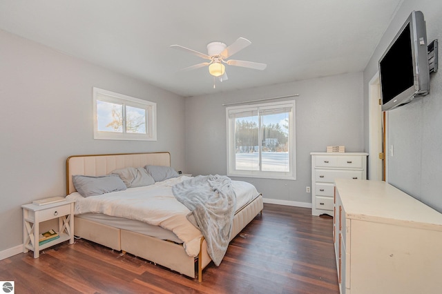 bedroom with dark wood finished floors, baseboards, and ceiling fan