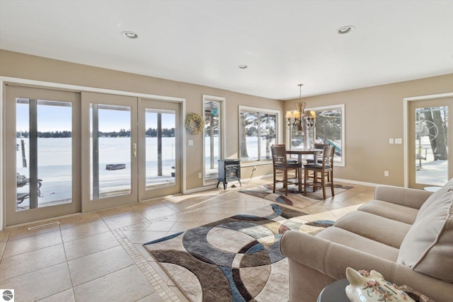 living room with recessed lighting, a water view, visible vents, and baseboards