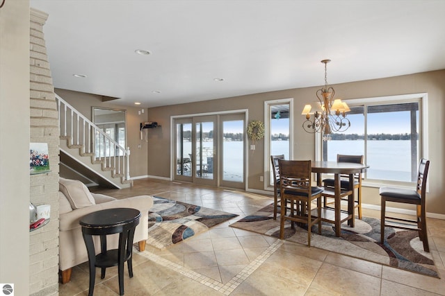 dining room with a water view, baseboards, a wealth of natural light, and recessed lighting