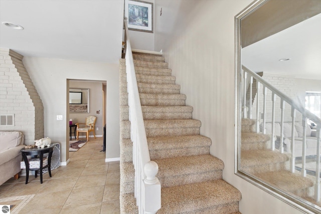 staircase with tile patterned flooring, visible vents, and baseboards