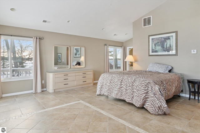 bedroom with vaulted ceiling, multiple windows, visible vents, and baseboards