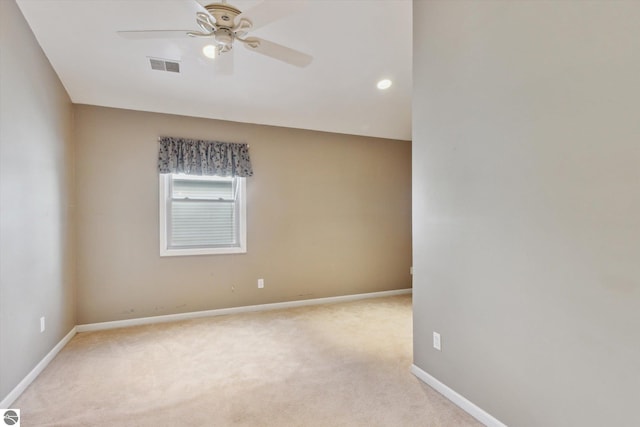 empty room featuring baseboards, a ceiling fan, visible vents, and light colored carpet