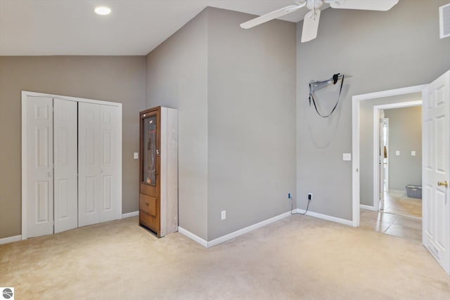 unfurnished bedroom featuring light carpet, baseboards, visible vents, a ceiling fan, and a closet