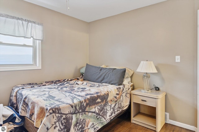 bedroom featuring dark wood-type flooring and baseboards