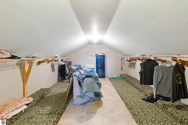 interior space with visible vents and vaulted ceiling