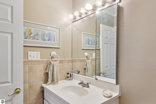 bathroom featuring vanity and tile walls