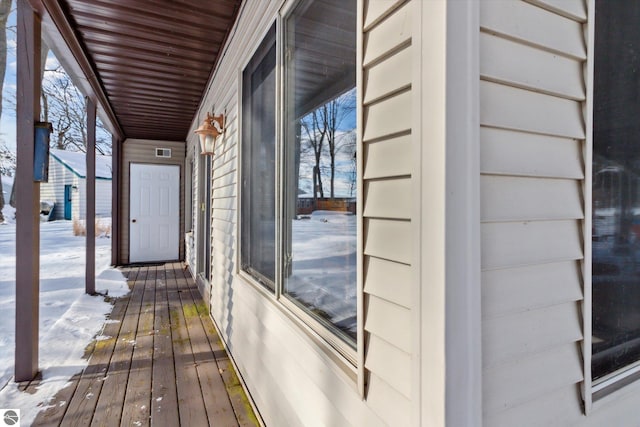 snow covered deck with visible vents