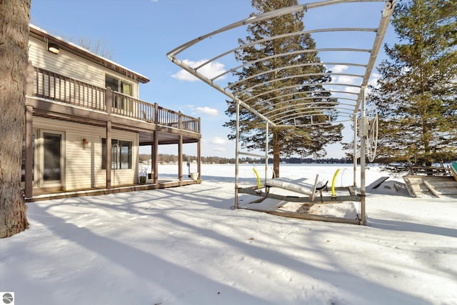 yard covered in snow featuring a balcony