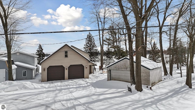 view of front facade featuring a garage and an outdoor structure