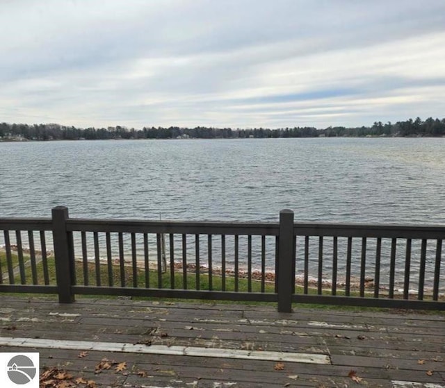 exterior space featuring a deck with water view