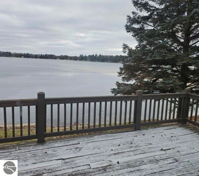 wooden terrace featuring a water view