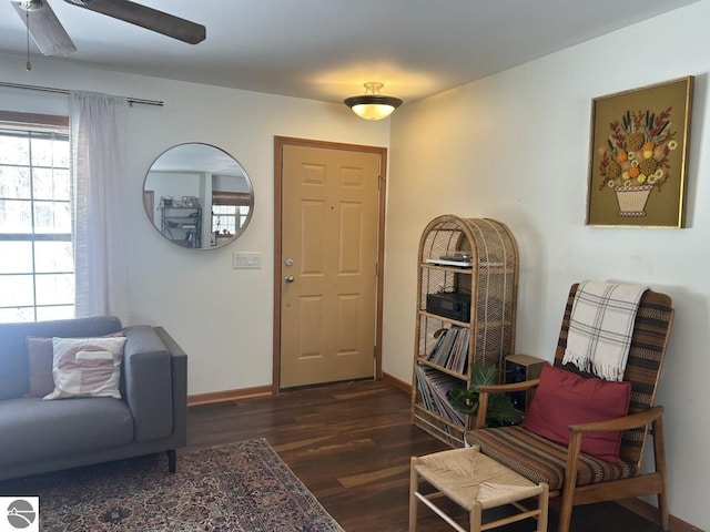 interior space featuring dark wood-style floors, baseboards, and a ceiling fan