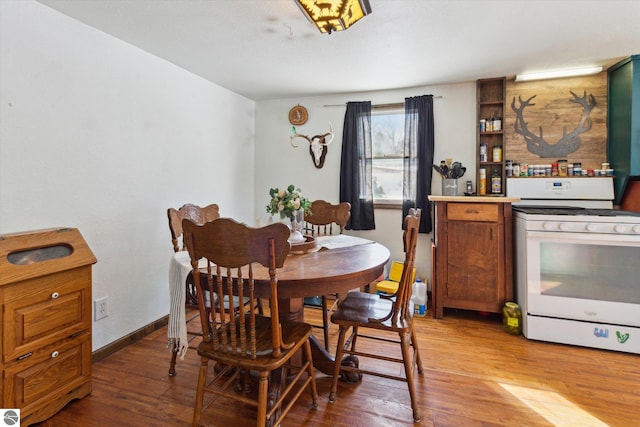 dining room featuring wood finished floors and baseboards