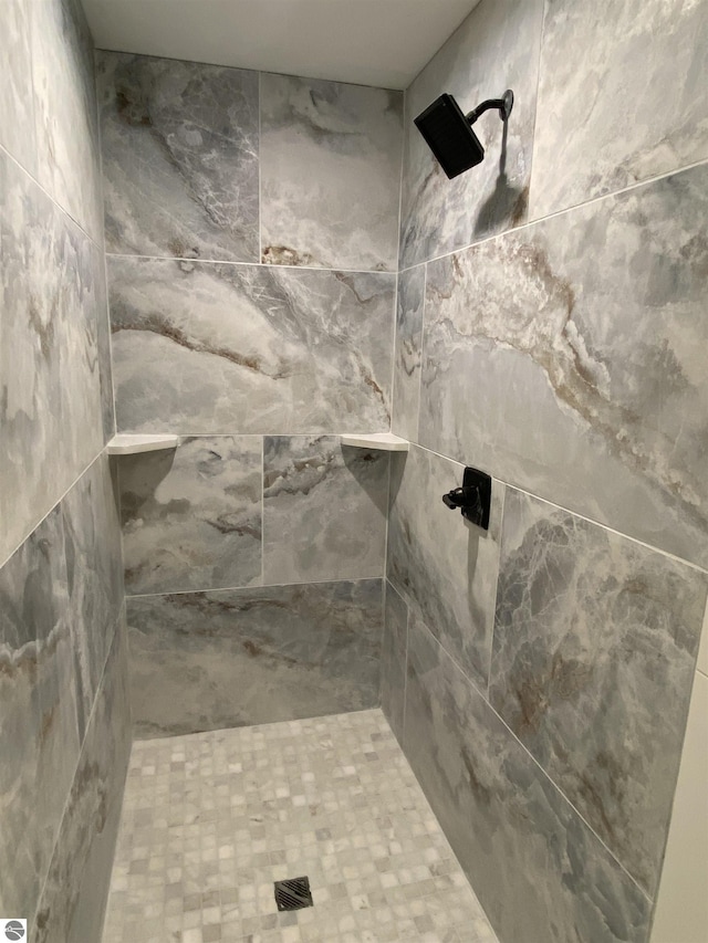 full bath with a tile shower