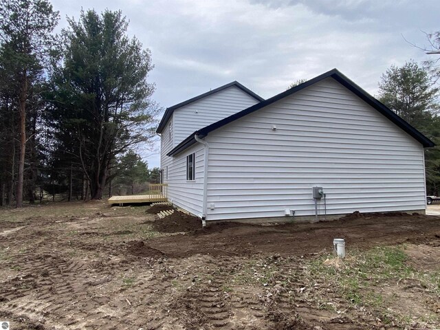 10402 Western Rd Unit 1, Rapid City, MI 49676 - view of home's exterior featuring a deck