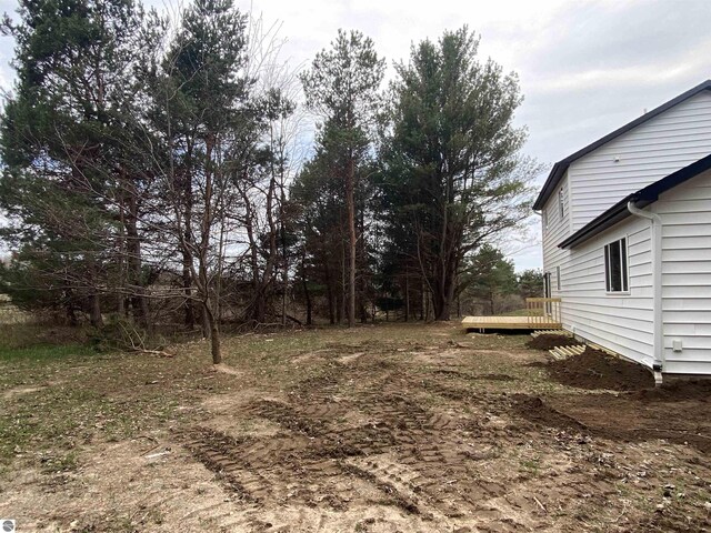 10402 Western Rd Unit 1, Rapid City, MI 49676 - view of yard featuring a deck