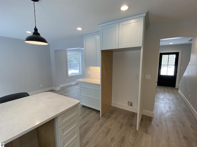 kitchen featuring pendant lighting, light countertops, and a healthy amount of sunlight