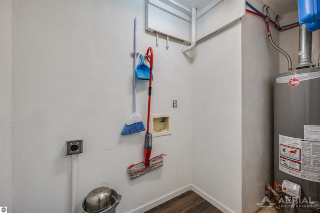 interior space featuring gas water heater, dark wood finished floors, hookup for a washing machine, hookup for an electric dryer, and laundry area